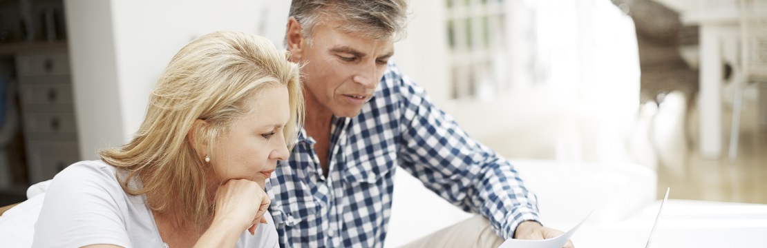 a man and woman looking at a document