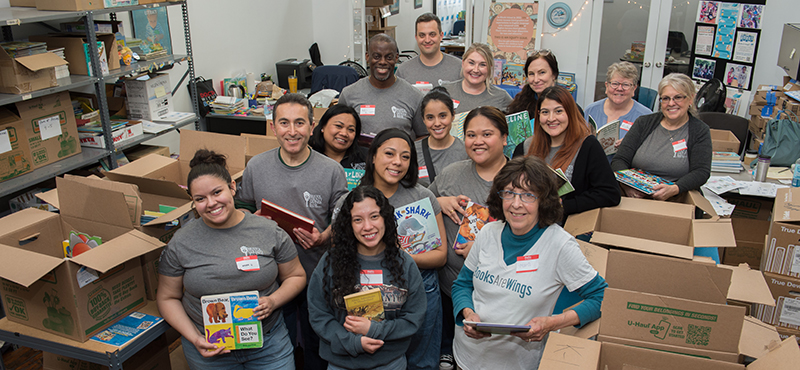 Bank President, John Silva, and employees volunteering at Books Are Wings