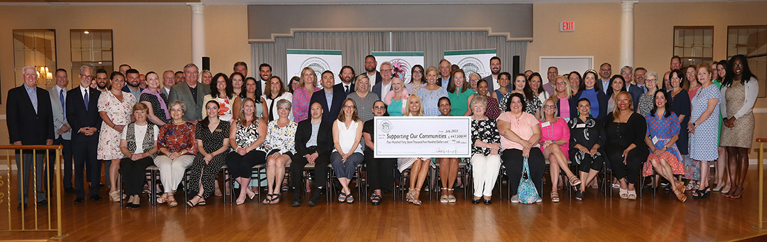 Representatives from 48 non-profit organizations are presented with a check for $447,500 in grant funding