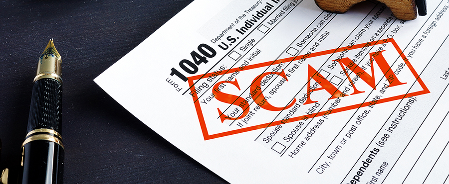Tax Form 1040 with "SCAM" in red letters