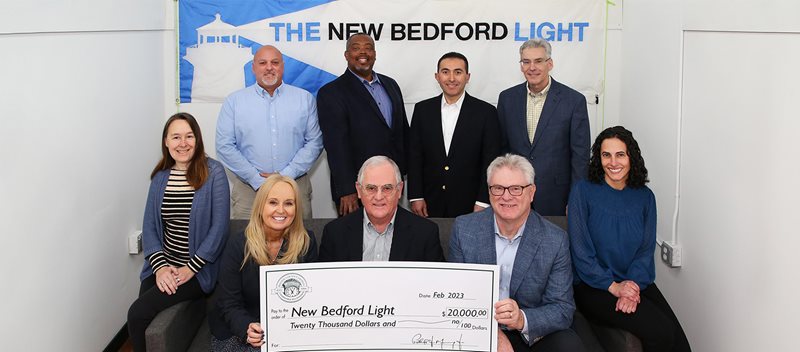 The New Bedford Light group accepting a $20,000 donation from Bristol County Savings Bank's foundation.